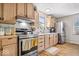 Well-equipped kitchen boasts stainless steel appliances and light wood cabinets at 10473 N County Road 950 E, Brownsburg, IN 46112
