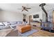 Comfortable living room featuring a plush sectional sofa, an area rug, and a rustic wood-burning stove at 10473 N County Road 950 E, Brownsburg, IN 46112