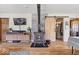 Inviting living room featuring stylish wood floors, a sliding barn door, and a vintage wood stove at 10473 N County Road 950 E, Brownsburg, IN 46112