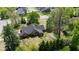 Aerial view of tan house with dark roof and manicured lawns surrounded by trees at 10602 Fall Rd, Fishers, IN 46037