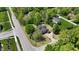 An aerial view of a single-Gathering home boasting mature landscaping, a circular driveway, and a well-maintained lawn at 10602 Fall Rd, Fishers, IN 46037