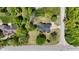 Birds eye view of a tan house with dark roof and verdant lawn with mature trees at 10602 Fall Rd, Fishers, IN 46037