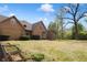 Expansive backyard with garden beds and well-maintained lawn at 10602 Fall Rd, Fishers, IN 46037