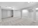Spacious basement with neutral carpeting, support beams, and built in storage at 10602 Fall Rd, Fishers, IN 46037