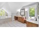 Bright bathroom featuring custom vanity, tile floors, and garden tub with natural light at 10602 Fall Rd, Fishers, IN 46037