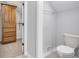 Bathroom with walk-in closet, toilet, and tile flooring at 10602 Fall Rd, Fishers, IN 46037