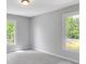 This bedroom has neutral carpet, two windows, and plenty of natural light at 10602 Fall Rd, Fishers, IN 46037