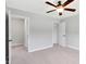 Spacious bedroom boasts neutral carpet, ceiling fan, and closet with ample storage space at 10602 Fall Rd, Fishers, IN 46037