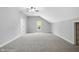 Spacious bonus room featuring neutral carpet, a window, and access to other rooms at 10602 Fall Rd, Fishers, IN 46037