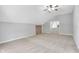 Spacious bonus room featuring neutral carpet, ceiling fan, and access to other rooms at 10602 Fall Rd, Fishers, IN 46037