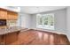 Bright dining area featuring a large bay window and wood floors at 10602 Fall Rd, Fishers, IN 46037