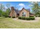 A well landscaped home with a stone chimney and arched window above the entrance at 10602 Fall Rd, Fishers, IN 46037