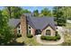 Beautiful home with stone chimney, black roof, and manicured front bushes at 10602 Fall Rd, Fishers, IN 46037