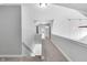 Long hallway with neutral carpet and white walls leads to multiple rooms at 10602 Fall Rd, Fishers, IN 46037