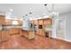 Large kitchen features an island, wood cabinets, granite countertops, and stainless steel appliances at 10602 Fall Rd, Fishers, IN 46037