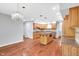 Open kitchen with wood cabinets, granite counters, central island, and modern lighting at 10602 Fall Rd, Fishers, IN 46037
