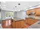 Well-appointed kitchen includes a large island, wooden cabinets, and modern appliances at 10602 Fall Rd, Fishers, IN 46037