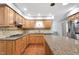 Charming kitchen features wood cabinets, granite counters, tiled backsplash, and gas range at 10602 Fall Rd, Fishers, IN 46037