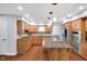 Updated kitchen with a large island, wood cabinetry, granite countertops, and tiled backsplash at 10602 Fall Rd, Fishers, IN 46037