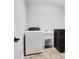 Practical laundry room with appliances, utility sink and tiled floors at 10602 Fall Rd, Fishers, IN 46037