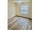 This bedroom has neutral walls, laminate flooring, a window with blinds, and electrical outlets at 1081 Torino Ln, Franklin, IN 46131