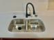 Stainless steel double sink with a sleek faucet set in a clean, white countertop at 1081 Torino Ln, Franklin, IN 46131
