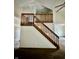 View of a two-story home's staircase with wooden railing, leading to the second floor at 1081 Torino Ln, Franklin, IN 46131