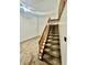 Staircase featuring carpeted steps and a wooden railing, blending functionality with visual appeal at 1081 Torino Ln, Franklin, IN 46131