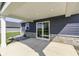Covered back patio with sliding glass doors and stone accents, with recessed lighting at 1115 Senate Dr, Edinburgh, IN 46124