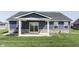 Covered back porch with sliding glass doors and stone accents, perfect for outdoor entertaining at 1115 Senate Dr, Edinburgh, IN 46124