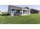 Backyard of home features a covered patio, stone accents, and a well-maintained lawn at 1115 Senate Dr, Edinburgh, IN 46124