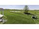 Gorgeous backyard with a pond, tall green grass and beautiful trees at 1115 Senate Dr, Edinburgh, IN 46124
