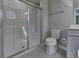 A clean bathroom with white tiled shower and grey tiled floor at 1115 Senate Dr, Edinburgh, IN 46124