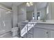 Modern bathroom with double vanity, bright mirror and a tiled walk-in shower at 1115 Senate Dr, Edinburgh, IN 46124