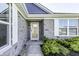 Elegant stone entryway with a glass front door and white framed windows and professionally landscaped at 1115 Senate Dr, Edinburgh, IN 46124