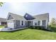 Charming front exterior showcasing a two-car garage, stone accents, and a landscaped yard at 1115 Senate Dr, Edinburgh, IN 46124