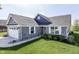 Charming front exterior showcasing a two-car garage, stone accents, and a landscaped yard at 1115 Senate Dr, Edinburgh, IN 46124