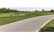 View of golf course with golfers, a paved path and surrounding trees at 1115 Senate Dr, Edinburgh, IN 46124
