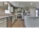 Bright kitchen featuring stainless appliances, granite counters, and island with seating at 1115 Senate Dr, Edinburgh, IN 46124
