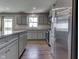A modern kitchen showcasing gray cabinetry, stainless steel appliances and hard surface countertops at 1115 Senate Dr, Edinburgh, IN 46124