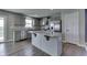 Well-lit kitchen boasts gray cabinets, granite countertops, and stainless steel appliances at 1115 Senate Dr, Edinburgh, IN 46124