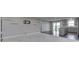 Open-concept living room featuring a kitchen, carpeted area, and sliding glass door at 1115 Senate Dr, Edinburgh, IN 46124