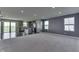 Spacious living area with open floor plan, carpeted floors, and a view of the modern kitchen at 1115 Senate Dr, Edinburgh, IN 46124