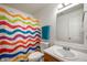Bright bathroom featuring a colorful shower curtain and updated vanity at 1257 Rosemary Ct, Greenfield, IN 46140