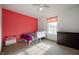 A bedroom features a twin bed with coral accent wall and carpeted flooring at 1257 Rosemary Ct, Greenfield, IN 46140