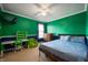 This bedroom features stylish green and blue walls, a desk, and ample space to relax at 1257 Rosemary Ct, Greenfield, IN 46140