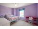 Bedroom with a bed, desk, and plush carpet under a ceiling fan at 1257 Rosemary Ct, Greenfield, IN 46140