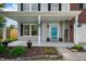 Inviting covered front porch with stylish decor, planters, and a 'Welcome' sign at 1257 Rosemary Ct, Greenfield, IN 46140