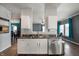 Modern kitchen with white cabinets, stainless steel appliances, and breakfast bar at 1257 Rosemary Ct, Greenfield, IN 46140