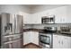 A kitchen featuring stainless steel appliances and white cabinets with granite countertops at 1257 Rosemary Ct, Greenfield, IN 46140